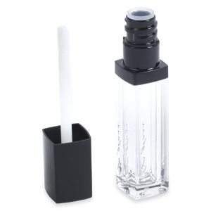 A tube of Square Lip Gloss with black accents is displayed against a white background. The cap is removed, revealing a white doe-foot applicator attached to it. The transparent container showcases the clear lip gloss inside.