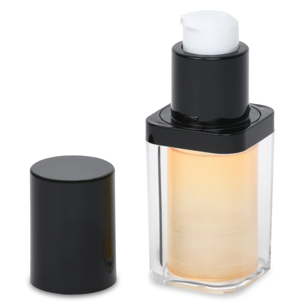 A clear airless pump bottle with a black and white pump dispenser top. The black cap is removed and placed beside the bottle.