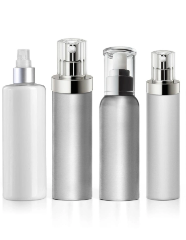 Four different cylindrical cosmetic bottles with dispensers. The first is white with a spray nozzle, and the remaining three are metallic silver with varying pump and spray lids.